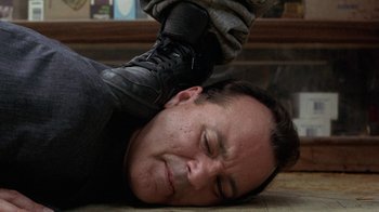 Movie still from “Mad Dog and Glory” (1993), directed by John McNaughton – A man laying on the ground with his head on the ground; Close Up shot, Low angle