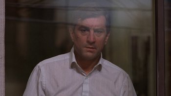 Movie still from “Mad Dog and Glory” (1993), directed by John McNaughton – A person wearing a white shirt; Close Up shot, Low angle