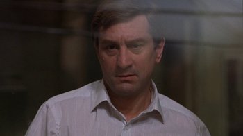 Movie still from “Mad Dog and Glory” (1993), directed by John McNaughton – A person wearing a white dress shirt; Close Up shot, Over the shoulder angle
