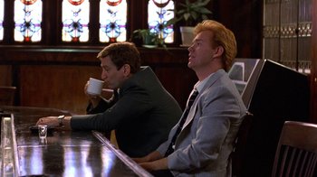 Movie still from “Mad Dog and Glory” (1993), directed by John McNaughton – A couple of men sitting at a table drinking coffee; Medium shot, Low angle