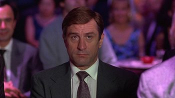 Movie still from “Mad Dog and Glory” (1993), directed by John McNaughton – A person wearing a suit and tie; Close Up shot, Over the shoulder angle