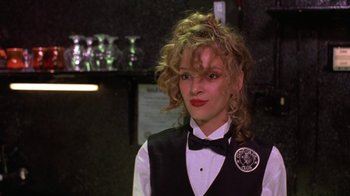 Movie still from “Mad Dog and Glory” (1993), directed by John McNaughton – A woman in a black vest and a black bow tie; Close Up shot, Over the shoulder angle