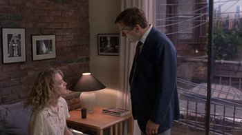 Movie still from “Mad Dog and Glory” (1993), directed by John McNaughton – A man and a woman standing in front of each other; Medium shot, Over the shoulder angle