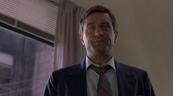 Movie still from “Mad Dog and Glory” (1993), directed by John McNaughton – A person wearing a suit and tie; Close Up shot, Low angle