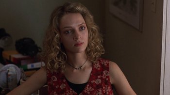 Movie still from “Mad Dog and Glory” (1993), directed by John McNaughton – A woman with blonde curly hair wearing a red dress; Close Up shot, High angle