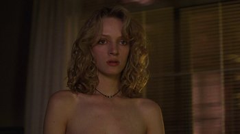 Movie still from “Mad Dog and Glory” (1993), directed by John McNaughton – A young woman with long blonde curly hair and bare breasts; Close Up shot, Over the shoulder angle