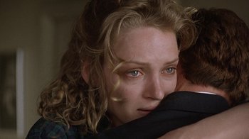 Movie still from “Mad Dog and Glory” (1993), directed by John McNaughton – A person holding a person's face; Close Up shot, Over the shoulder angle