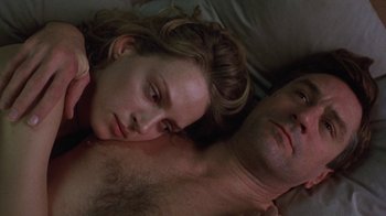 Movie still from “Mad Dog and Glory” (1993), directed by John McNaughton – A man and a woman laying in bed together; Close Up shot, Overhead angle