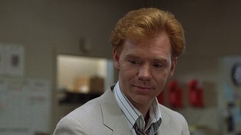 Movie still from “Mad Dog and Glory” (1993), directed by John McNaughton – A man with red hair wearing a suit and tie; Close Up shot, Over the shoulder angle