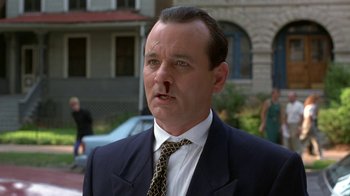 Movie still from “Mad Dog and Glory” (1993), directed by John McNaughton – A man in a suit and a tie; Close Up shot, Low angle