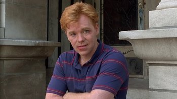Movie still from “Mad Dog and Glory” (1993), directed by John McNaughton – A man with red hair and a blue and red striped shirt; Close Up shot, High angle