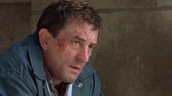 Movie still from “Mad Dog and Glory” (1993), directed by John McNaughton – A person with a bruise on his face; Close Up shot, Low angle