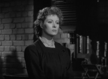 Movie still from “Madame Curie” (1943), directed by Mervyn LeRoy – An old black and white photo of a woman; Close Up shot, Low angle