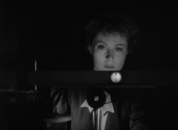 Movie still from “Madame Curie” (1943), directed by Mervyn LeRoy – A black - and - white photo of a woman looking at the camera; Medium shot, Low angle