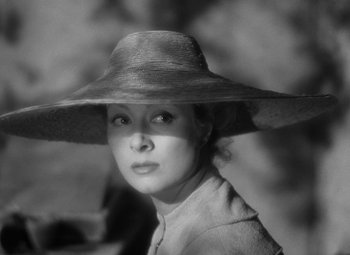Movie still from “Madame Curie” (1943), directed by Mervyn LeRoy – A black and white photo of a woman wearing a hat; Close Up shot, High angle