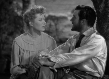 Movie still from “Madame Curie” (1943), directed by Mervyn LeRoy – A man and a woman holding each other's hands; Medium shot, High angle