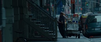Movie still from “Made of Honor” (2008), directed by Paul Weiland – A man standing on the sidewalk near a staircase; Wide shot, Low angle