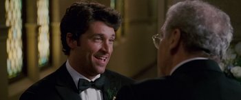 Movie still from “Made of Honor” (2008), directed by Paul Weiland – A man in a tuxedo talking to another man in a suit; Close Up shot, Over the shoulder angle