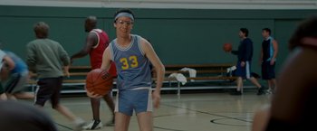 Movie still from “Made of Honor” (2008), directed by Paul Weiland – A man in a blue and white basketball uniform is holding a basketball; Medium shot, High angle