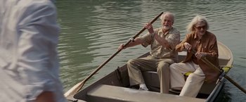 Movie still from “Made of Honor” (2008), directed by Paul Weiland – An old man sitting in a small boat holding a paddle; Wide shot, Low angle