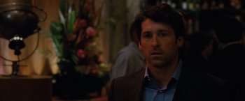 Movie still from “Made of Honor” (2008), directed by Paul Weiland – A man in a brown suit and a blue shirt; Close Up shot, Over the shoulder angle