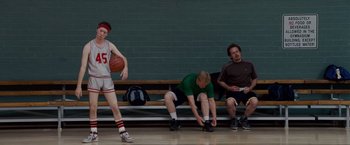 Movie still from “Made of Honor” (2008), directed by Paul Weiland – A group of men sitting on a bench in a gym; Wide shot, Low angle
