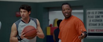 Movie still from “Made of Honor” (2008), directed by Paul Weiland – Two men are standing in a gym holding a basketball; Close Up shot, Over the shoulder angle