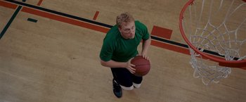 Movie still from “Made of Honor” (2008), directed by Paul Weiland – A man holding a basketball on top of a basketball court; Close Up shot, Overhead angle