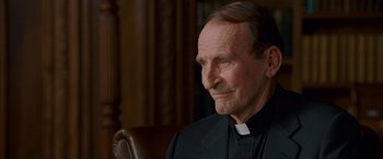 Movie still from “Made of Honor” (2008), directed by Paul Weiland – An older man wearing a priest's outfit; Close Up shot, Low angle