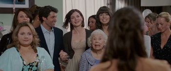 Movie still from “Made of Honor” (2008), directed by Paul Weiland – A group of people standing next to each other in a room; Medium shot, Over the shoulder angle