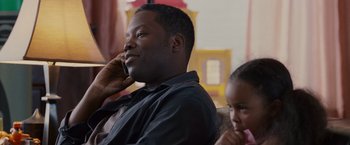 Movie still from “Made of Honor” (2008), directed by Paul Weiland – A man sitting on a couch talking on a cell phone; Close Up shot, Over the shoulder angle