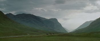 Movie still from “Made of Honor” (2008), directed by Paul Weiland – A herd of sheep walking down a road near a mountain; Extreme Wide shot, Low angle