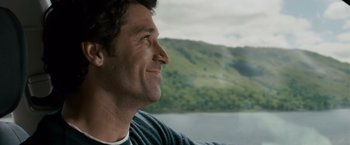 Movie still from “Made of Honor” (2008), directed by Paul Weiland – A person sitting in a chair near a body of water; Close Up shot, Over the shoulder angle