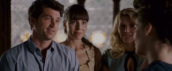 Movie still from “Made of Honor” (2008), directed by Paul Weiland – A group of people standing next to each other in a room; Close Up shot, Over the shoulder angle