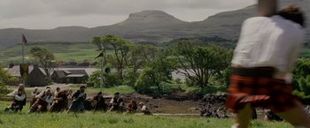 Movie still from “Made of Honor” (2008), directed by Paul Weiland – A group of people sitting in a grassy field; Extreme Wide shot, High angle