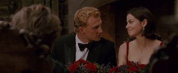 Movie still from “Made of Honor” (2008), directed by Paul Weiland – A man in a tuxedo and a bow tie at a formal event; Medium shot, Over the shoulder angle