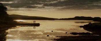 Movie still from “Made of Honor” (2008), directed by Paul Weiland – Two people standing on the shore of a body of water; Extreme Wide shot, Low angle