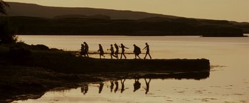 Movie still from “Made of Honor” (2008), directed by Paul Weiland – A group of people walking across a beach; Extreme Wide shot, High angle