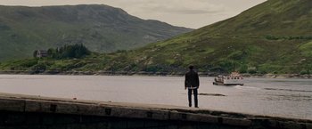 Movie still from “Made of Honor” (2008), directed by Paul Weiland – A man standing on the side of a river looking out at a mountain; Extreme Wide shot, High angle
