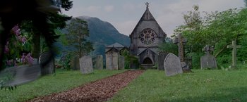 Movie still from “Made of Honor” (2008), directed by Paul Weiland – An old cemetery with a church in the background; Extreme Wide shot, Low angle