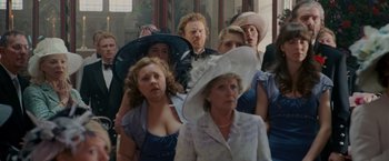 Movie still from “Made of Honor” (2008), directed by Paul Weiland – A group of people wearing hats in a room; Close Up shot, Over the shoulder angle