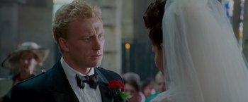 Movie still from “Made of Honor” (2008), directed by Paul Weiland – A person wearing a suit and a bow tie; Close Up shot, Over the shoulder angle
