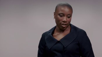 Movie still from “Madea Goes to Jail” (2009), directed by Tyler Perry – A woman in a black jacket is looking down; Close Up shot, Over the shoulder angle