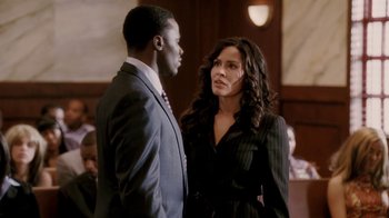 Movie still from “Madea Goes to Jail” (2009), directed by Tyler Perry – A man and a woman standing next to each other in a courtroom; Medium shot, Over the shoulder angle