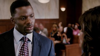 Movie still from “Madea Goes to Jail” (2009), directed by Tyler Perry – A man in a suit and tie in a court room; Close Up shot, High angle
