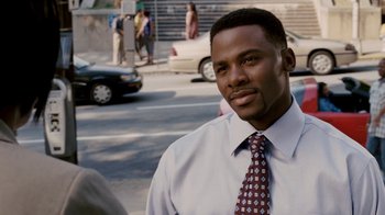 Movie still from “Madea Goes to Jail” (2009), directed by Tyler Perry – A man wearing a white dress shirt and a red tie; Close Up shot, High angle