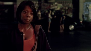 Movie still from “Madea Goes to Jail” (2009), directed by Tyler Perry – A woman standing in front of a group of people; Close Up shot, Over the shoulder angle