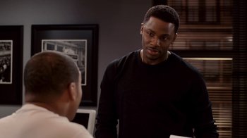 Movie still from “Madea Goes to Jail” (2009), directed by Tyler Perry – A man talking to another man in front of a laptop; Medium shot, Over the shoulder angle