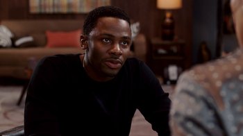 Movie still from “Madea Goes to Jail” (2009), directed by Tyler Perry – A man sitting in front of a lamp in a living room; Close Up shot, Over the shoulder angle