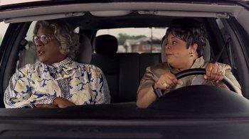 Movie still from “Madea Goes to Jail” (2009), directed by Tyler Perry – Two women sitting in the back seat of a car; Medium shot, Over the shoulder angle